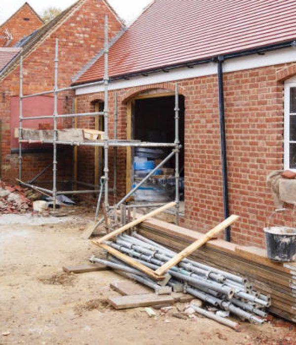 Building site in UK with brick house extension under construction